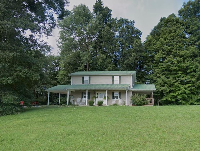 farmhouse with a porch, a carport, and a front yard