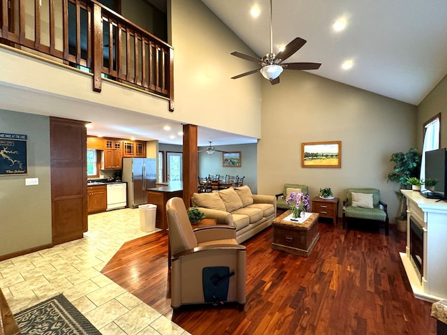 living room with high vaulted ceiling, baseboards, dark wood-style flooring, and a ceiling fan