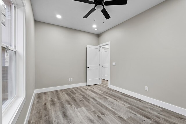 spare room featuring recessed lighting, ceiling fan, light wood finished floors, and baseboards