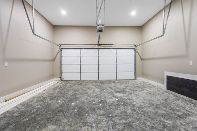 garage with a garage door opener and baseboards