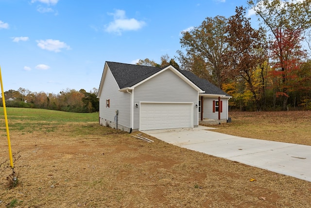 view of home's exterior with a garage, driveway, and a yard