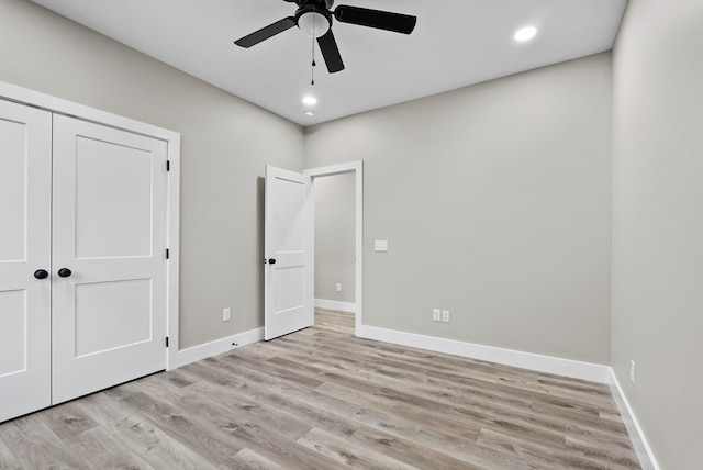 unfurnished bedroom featuring light wood finished floors, baseboards, and recessed lighting