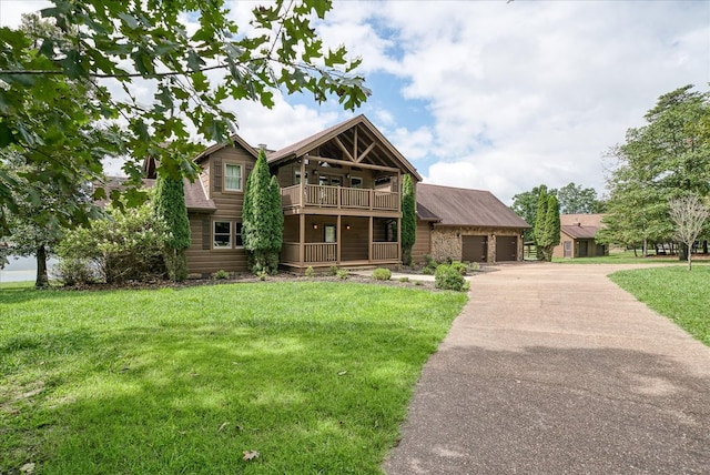 view of front facade featuring a porch, an attached garage, a front yard, a balcony, and driveway