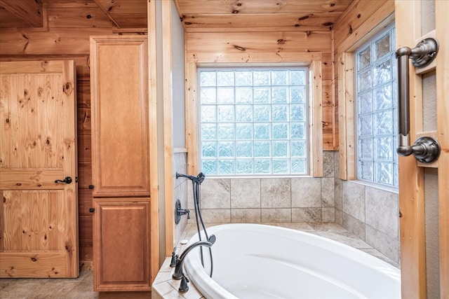 bathroom with a wealth of natural light and a garden tub