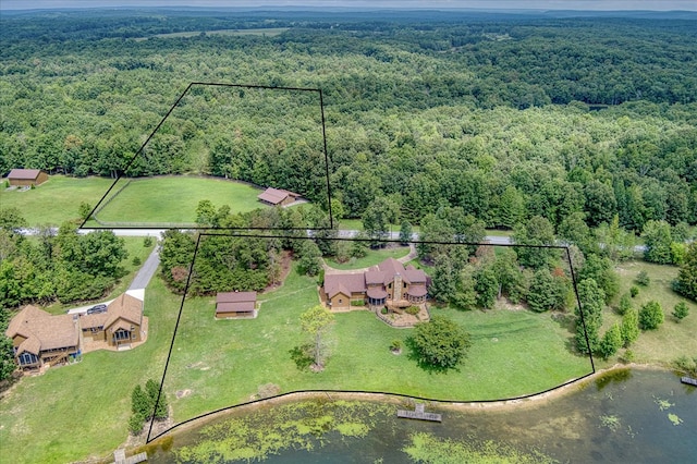 drone / aerial view with a water view and a wooded view