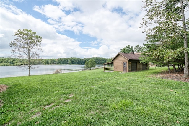 view of yard with an outbuilding and a water view