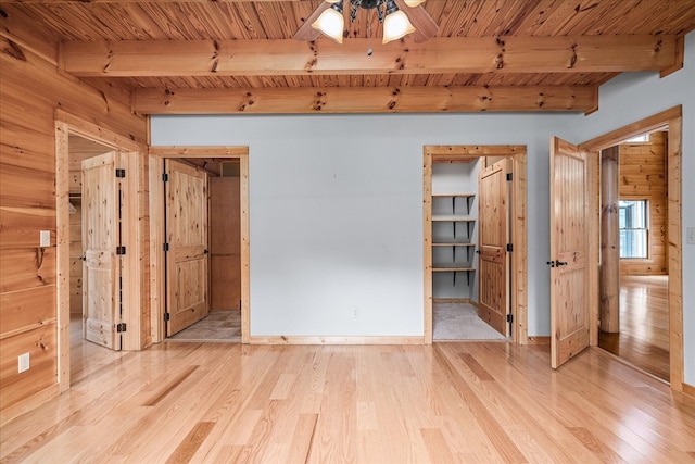 unfurnished room featuring wooden ceiling, wood finished floors, and beamed ceiling