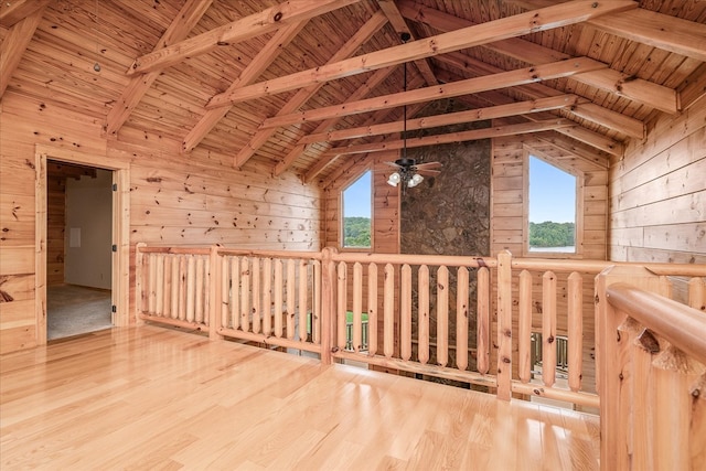 bonus room featuring beam ceiling, wood ceiling, wooden walls, wood finished floors, and high vaulted ceiling