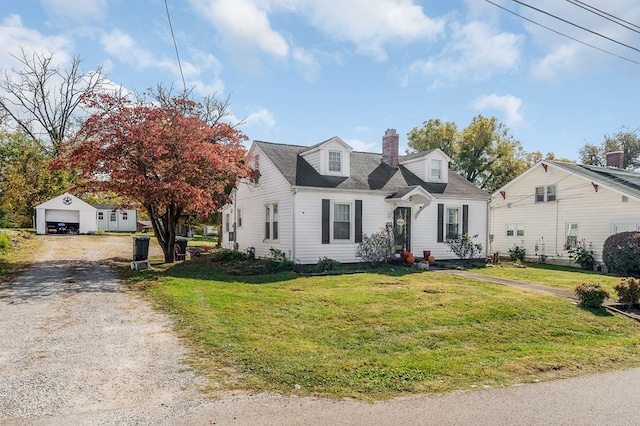 cape cod-style house with an outbuilding, a chimney, dirt driveway, a garage, and a front lawn