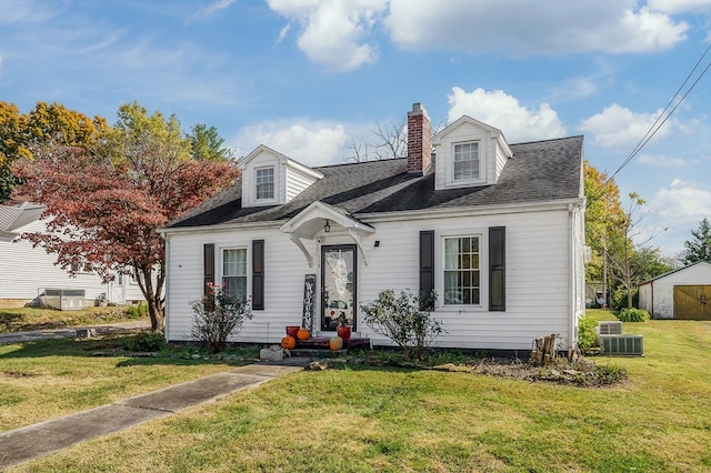 cape cod-style house featuring a front yard, roof with shingles, a chimney, and central AC unit