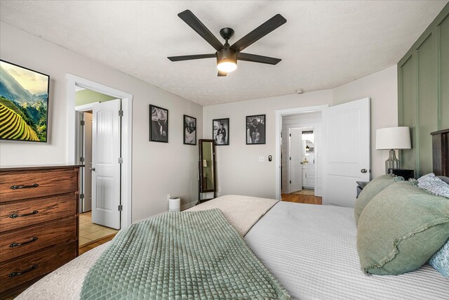 bedroom with a textured ceiling and a ceiling fan