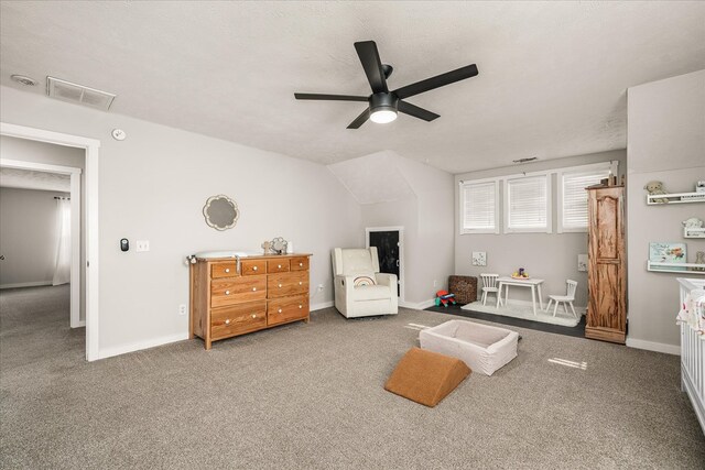 interior space featuring a textured ceiling, a ceiling fan, visible vents, and baseboards