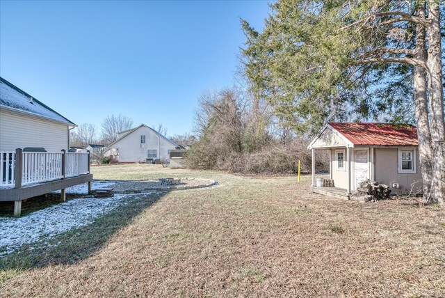 view of yard with a deck and an outbuilding