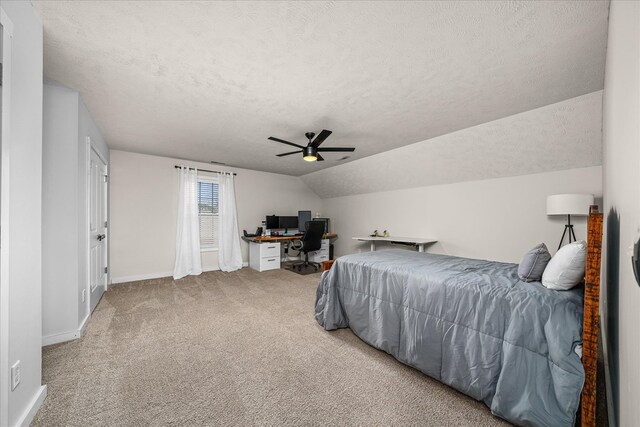 carpeted bedroom featuring a ceiling fan, lofted ceiling, a textured ceiling, and baseboards