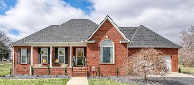 view of front of house featuring a porch, an attached garage, brick siding, concrete driveway, and roof with shingles