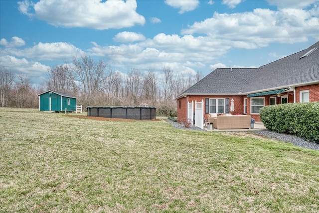 view of yard featuring a storage unit, an outdoor hangout area, a patio area, an outdoor pool, and an outdoor structure