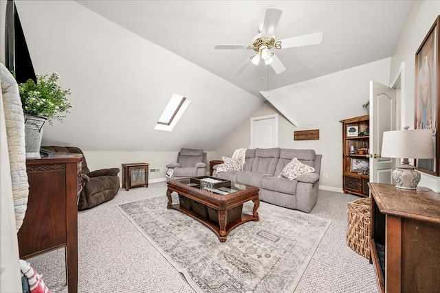 carpeted living area with lofted ceiling with skylight, baseboards, and a ceiling fan