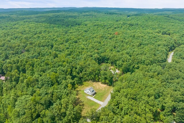 bird's eye view featuring a wooded view