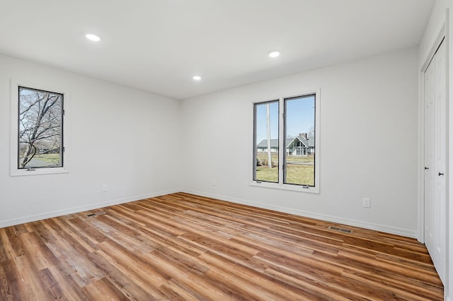 unfurnished bedroom with recessed lighting, visible vents, baseboards, and light wood finished floors