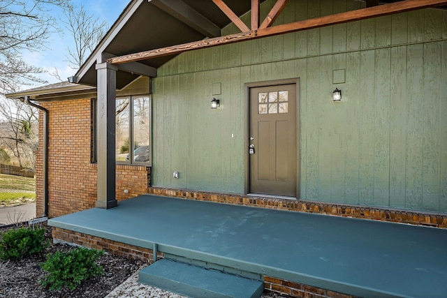 entrance to property featuring brick siding