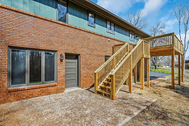 view of patio with a deck and stairway