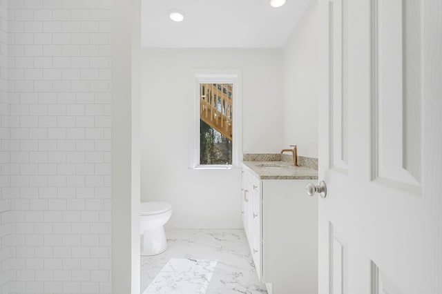 bathroom featuring recessed lighting, toilet, marble finish floor, and vanity