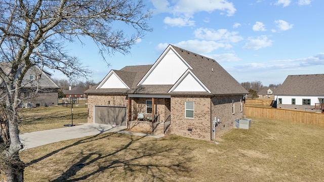 view of front facade featuring brick siding, fence, driveway, crawl space, and a front yard