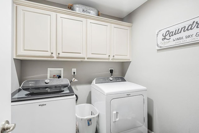 washroom featuring cabinet space and separate washer and dryer