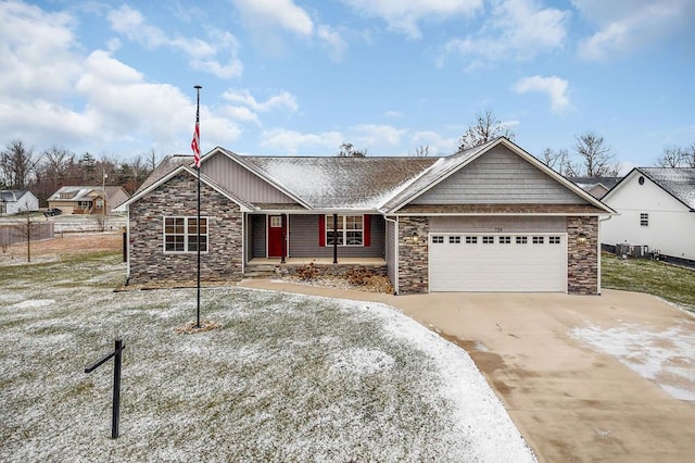 view of front of home featuring a garage, stone siding, and concrete driveway