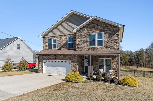 craftsman-style home with a garage, driveway, a front lawn, and fence