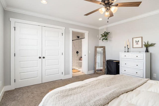 bedroom featuring a closet, light colored carpet, ornamental molding, ensuite bath, and baseboards