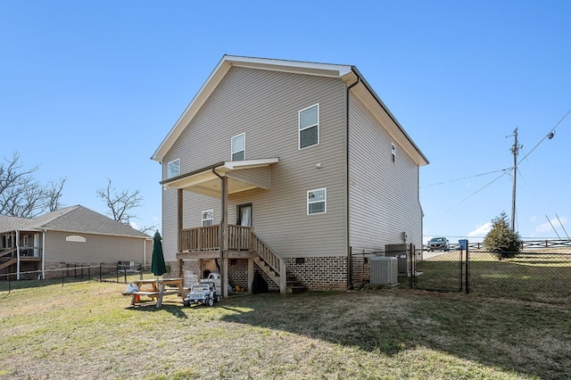 rear view of house with fence private yard, a gate, a lawn, and central air condition unit