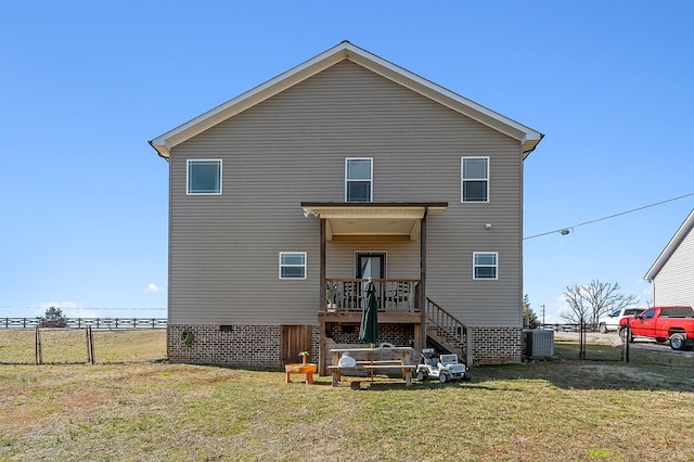 rear view of property with a lawn, a gate, stairs, fence, and central AC