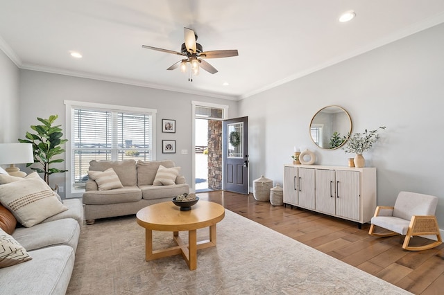 living room featuring a ceiling fan, recessed lighting, crown molding, and wood finished floors