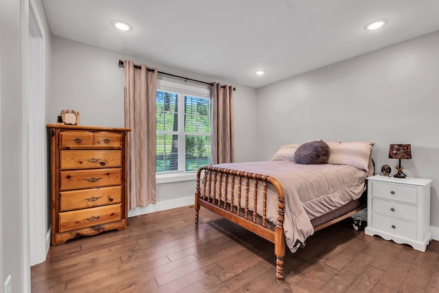 bedroom featuring baseboards, dark wood finished floors, and recessed lighting