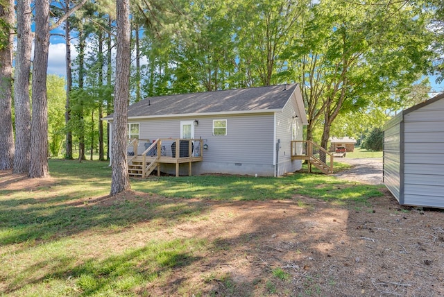 back of house featuring crawl space, stairs, a deck, and a yard