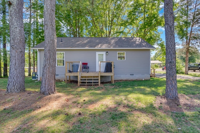 rear view of house featuring crawl space, a yard, and a wooden deck