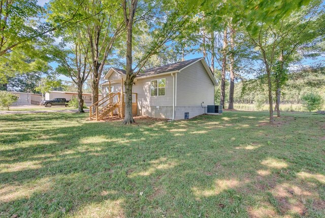 exterior space featuring a yard and central AC unit