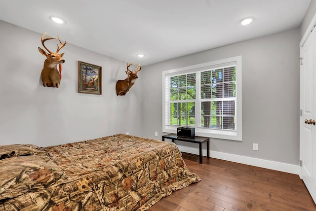 bedroom featuring recessed lighting, dark wood finished floors, and baseboards