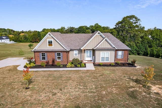 craftsman house with brick siding, board and batten siding, and a front yard