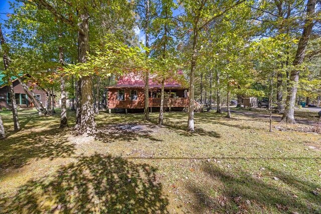 exterior space with a front lawn and a wooden deck