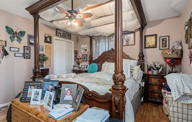 bedroom with decorative columns and light wood-style floors