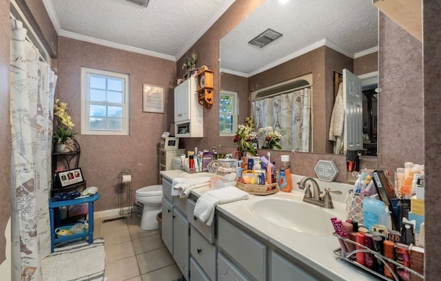 bathroom with vanity, tile patterned flooring, toilet, and a healthy amount of sunlight