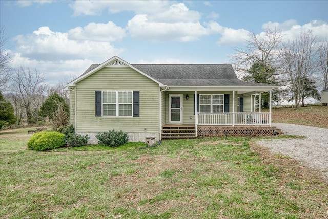 view of front of property with gravel driveway, a shingled roof, a front lawn, and a porch