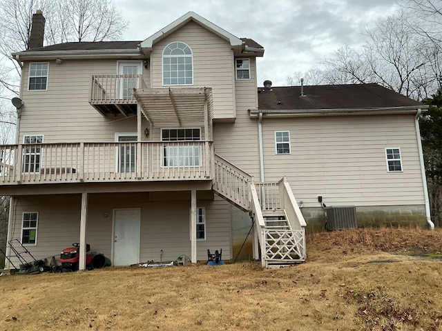 rear view of house featuring central air condition unit, a chimney, and stairway