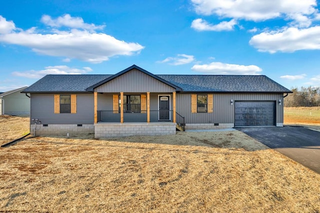 view of front of house featuring a porch, an attached garage, a shingled roof, driveway, and crawl space