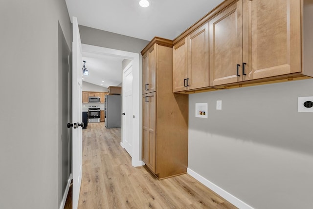 interior space featuring baseboards, vaulted ceiling, and light wood finished floors