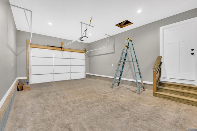 garage featuring recessed lighting and baseboards