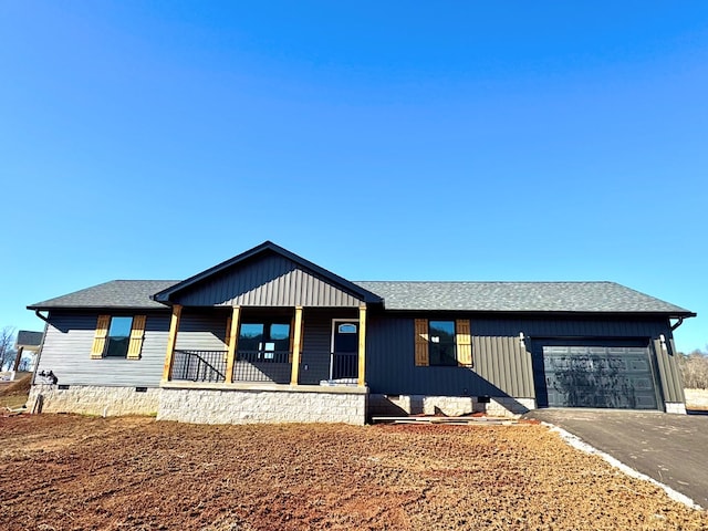 view of front facade featuring roof with shingles, a porch, an attached garage, crawl space, and driveway