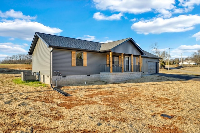 view of front of home with cooling unit, a garage, covered porch, a shingled roof, and crawl space